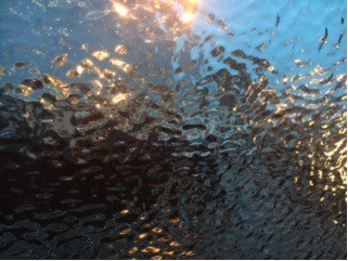 Coloured image of light through a windshield, water, and ice.